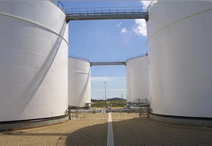 Storage tanks connected by an elevated walkway